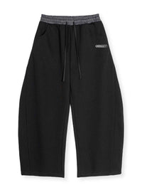 PANTALONI DI TUTA CON ELASTCO IN VITA A QUADRI E GAMBA CURVA STREETWEAR